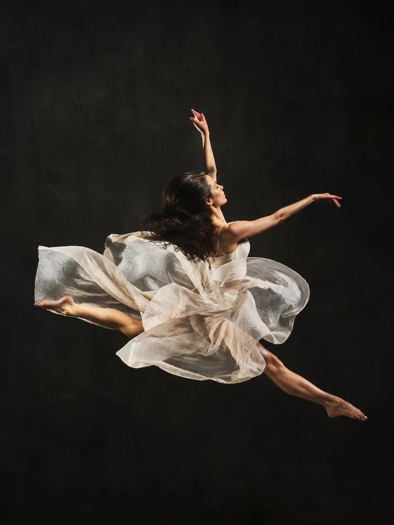 Studio portrait of a dancer mid-leap, dramatic rim lighting, flowing fabric, dark background